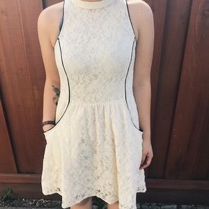 Off-white formal dress with floral inlaid designs.